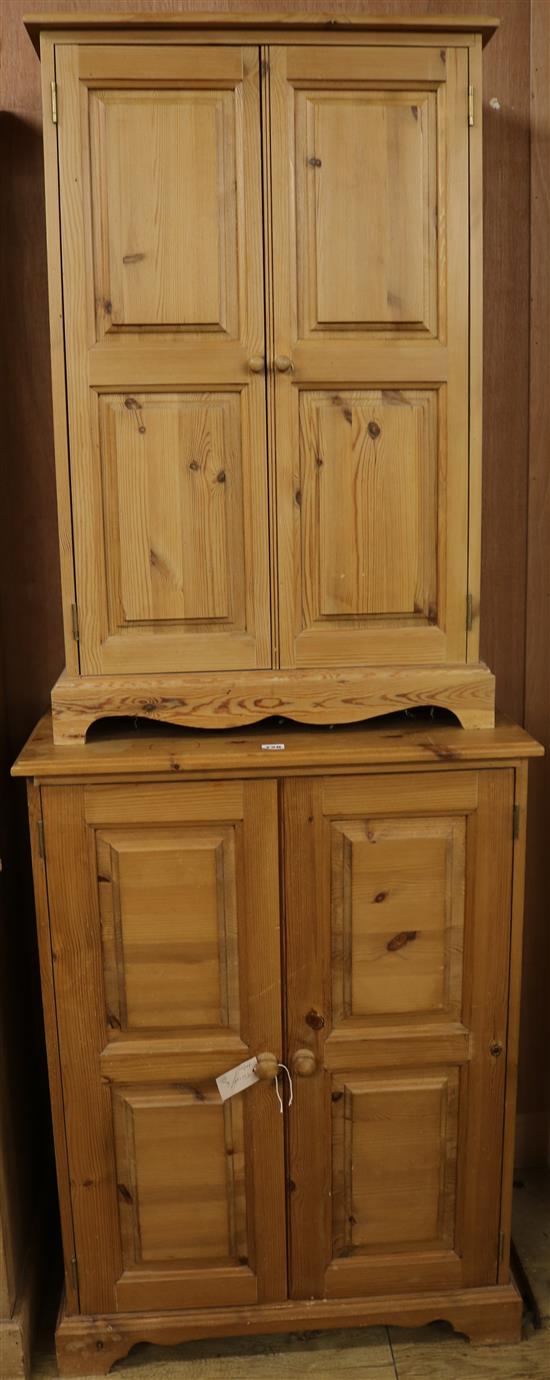 A pair of pine two-door cupboards, H.100cm & H.98cm